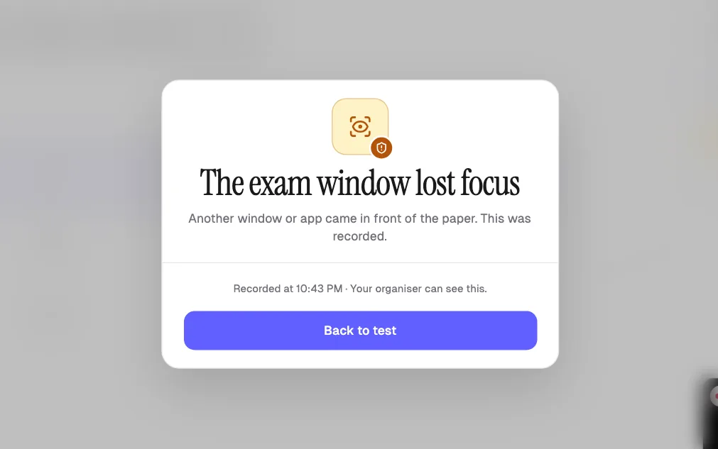 Exam paper blurred after the student switched windows, with a stay with the paper warning